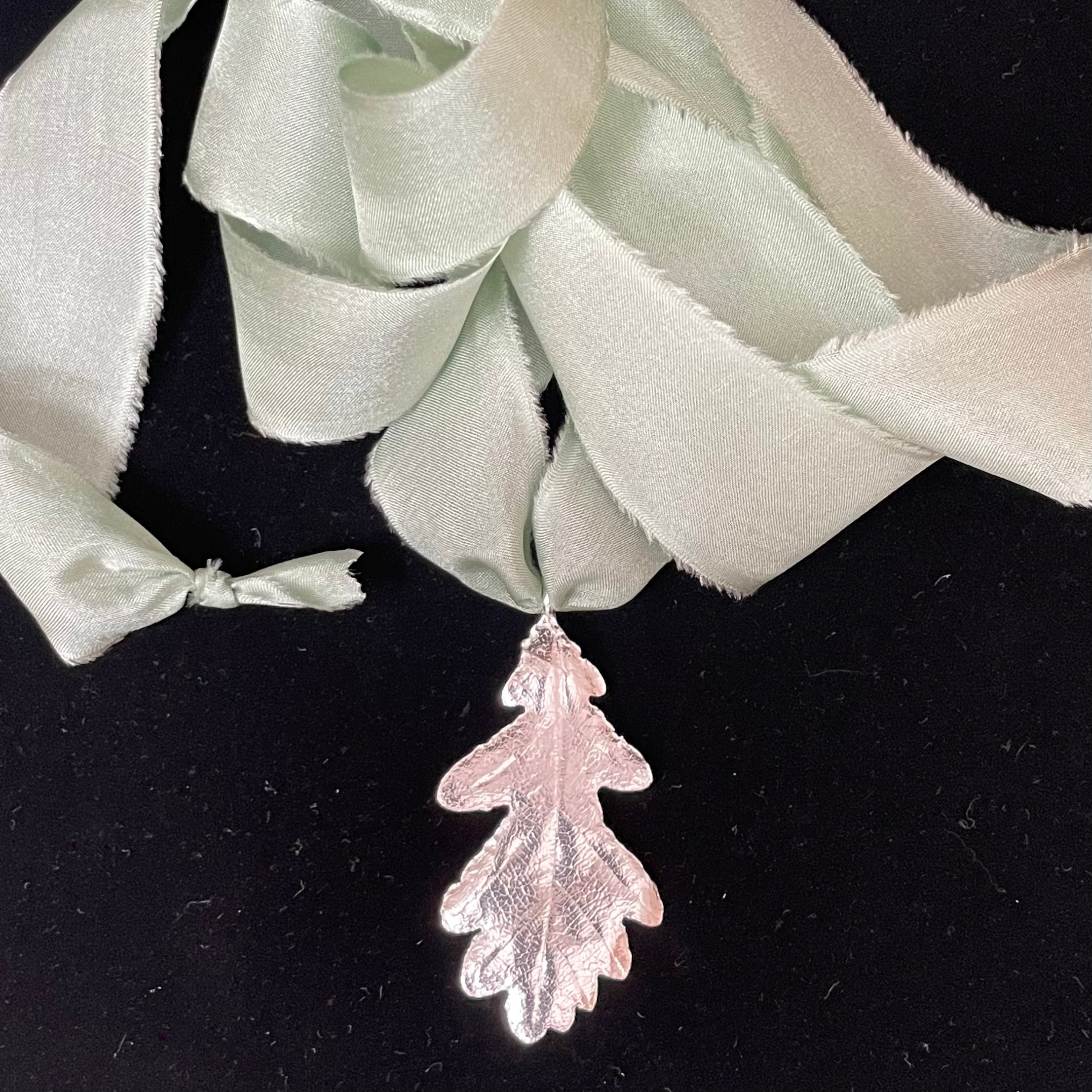 Oak leaf pendant on silk ribbon