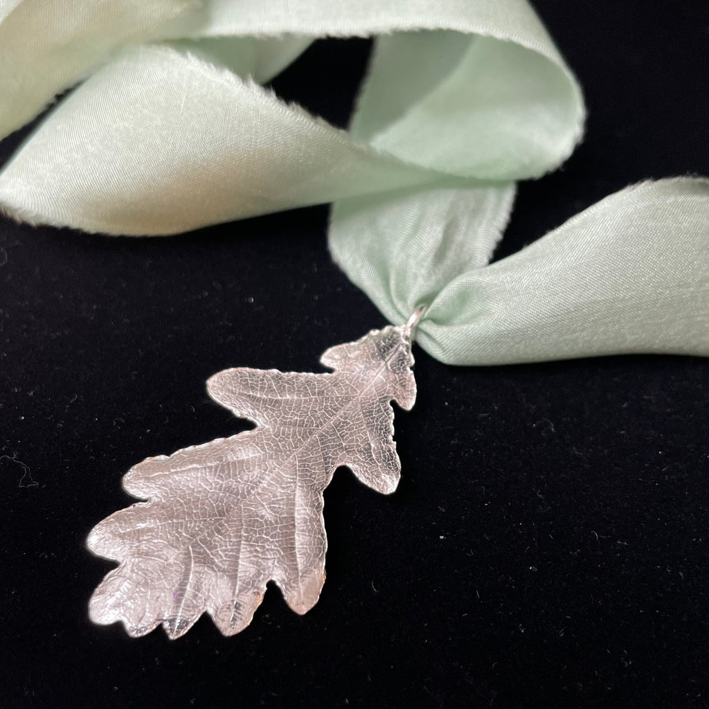 Oak leaf pendant on silk ribbon