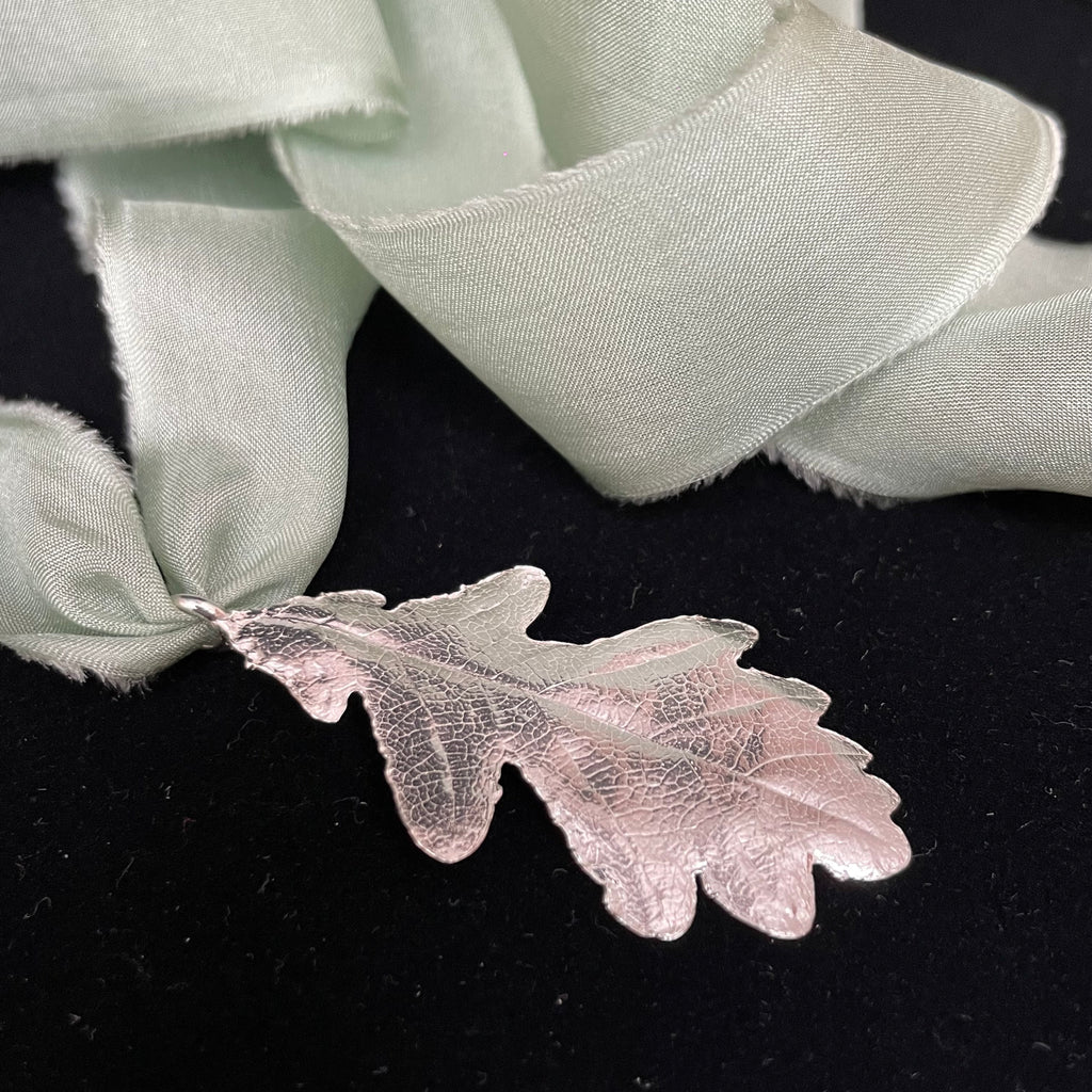 Oak leaf pendant on silk ribbon
