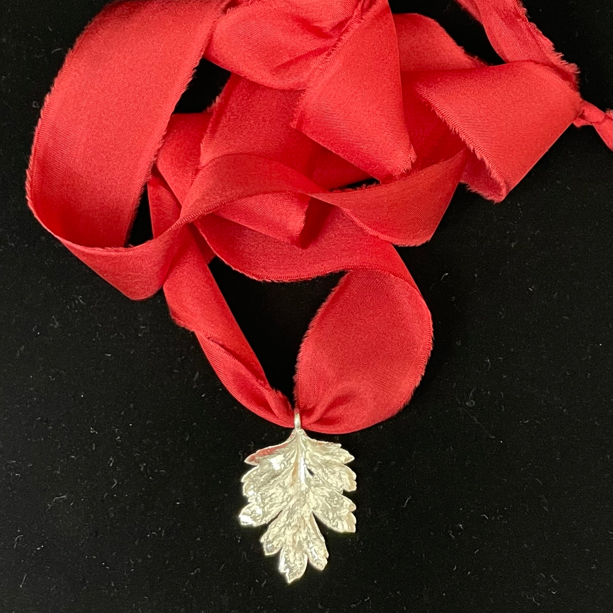 Hawthorn leaf pendant on silk ribbon