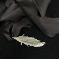 Feather pendant on silk ribbon